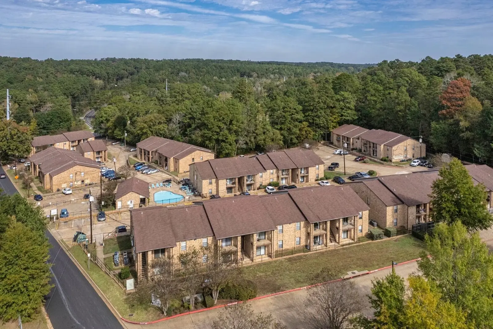 Aerial view of Chevy Chase Apartments surrounded by trees.