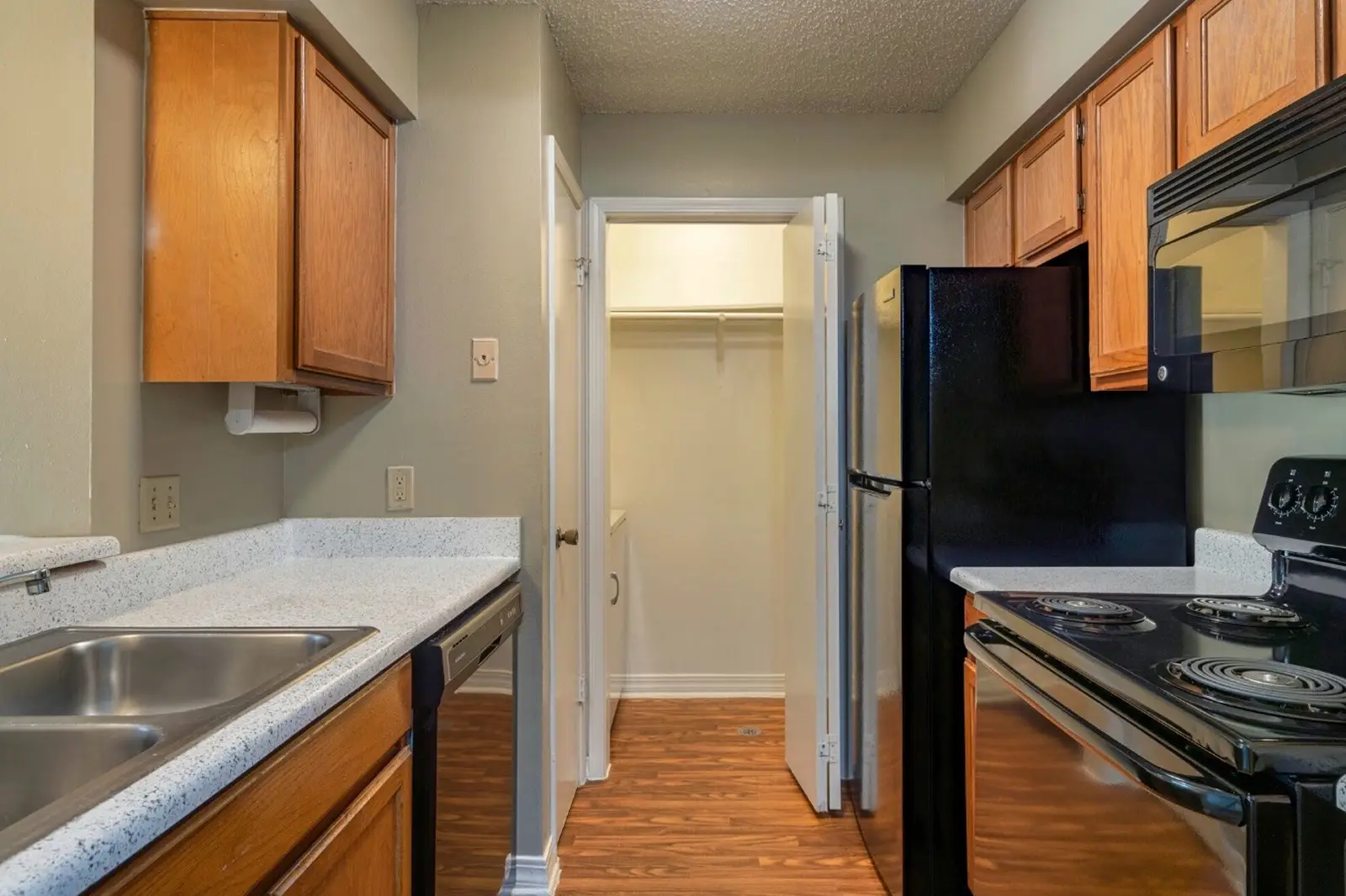 Kitchen with view into laundry closet and washer.